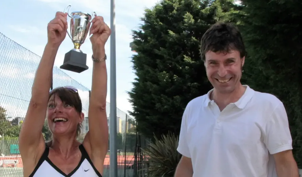 Two members celebrating with a trophy at a Blackheath Lawn Tennis Club presentation