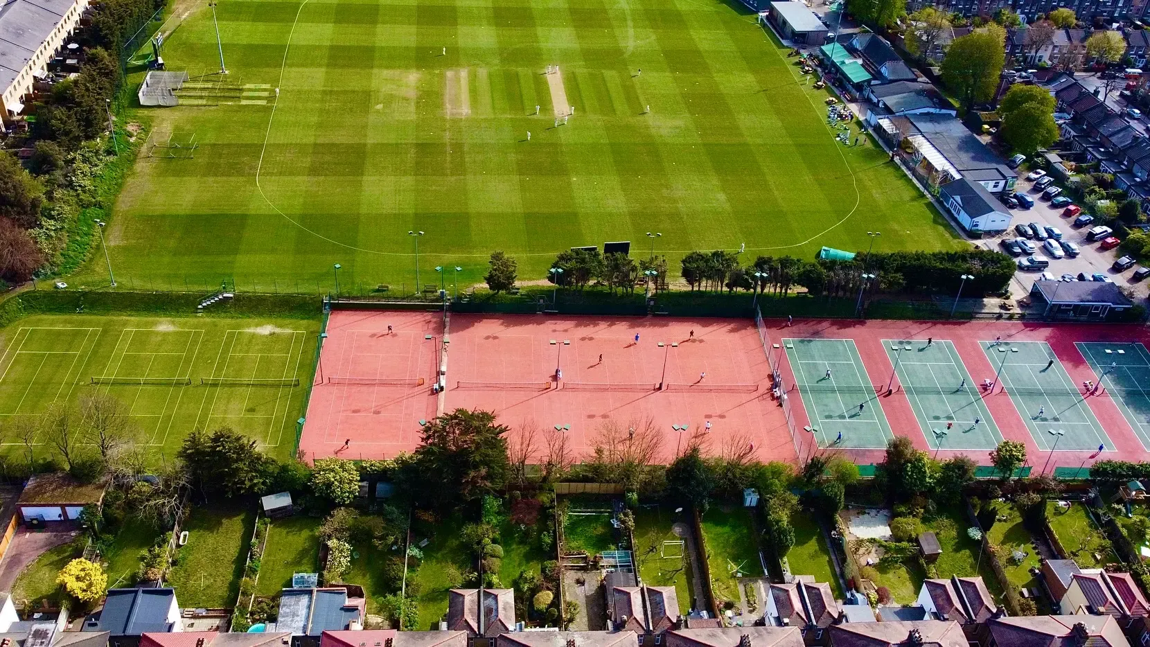 An aerial view of Blackheath Lawn Tennis Club, showing the grass, clay and hard courts alongside the Rectory Field cricket ground