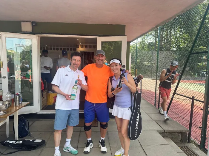 Three members toasting with wine after a match