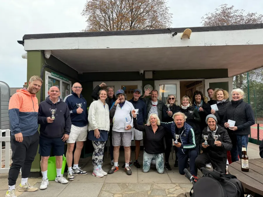 Members gathered outside the clubhouse with trophies after a club tournament