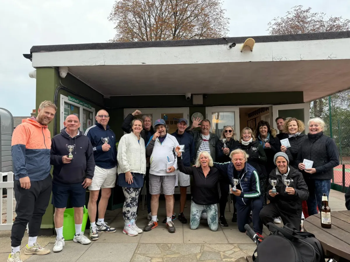 Members celebrating with trophies outside the clubhouse after a tournament